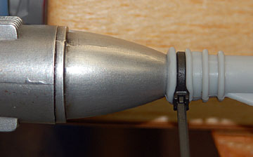 Put a zip tie around the deflector in front of the screws.