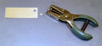 A hole punch can punch clean circles from thin plywood.
