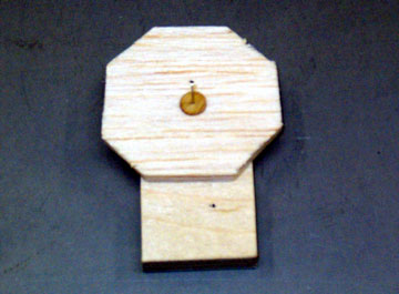 A dress-maker's pin holds the plug to a plywood base and allows the plug to be rotated.