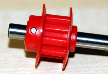 Press the pulley and flange together and line the pulley up with the hole in the shaft.  Insert the pin.