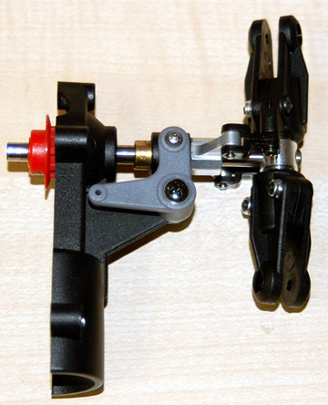 Place the larger hole in the lever over the ball in the tail pitch control slider.  Screw the lever in place.