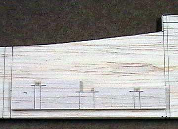 The servo rail supports are located so that the bottoms of the servos do not contact the fuselage.