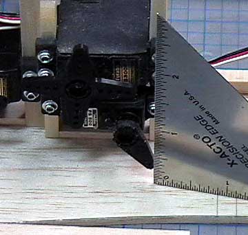 Measure the distance of the servo arm from the fuselage side.  Transfer the measurement to the former in front of the servo.