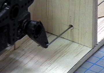 Drill a hole in the former at the intersection of the two measurements.