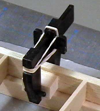 Hinge support blocks clamped in front of the trailing edge of the wing.