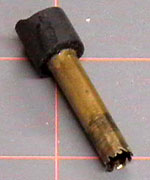 A piece of brass tubing that is notched to act as a hole saw.