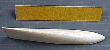 Coarse sandpaper is the next step after completing the rasp work.