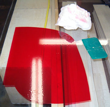 Wet the covering with more window cleaner. Squeegee the film smooth and flat.