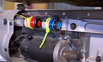 Attach the jar of paint to the saw arm with the foam rubber contacting the jar. Be sure the Zip tie is snug and then check that the jar of paint is very secure.