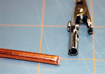 Find a metal rod that fits inside the shank of the alligator clip.