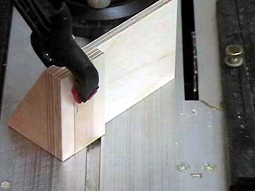 A vertical press blank clamped in the sawing fixture.