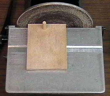 A fixture made to radius the front of the vertical press.
