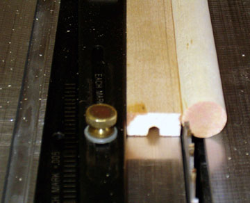 Set the saw to provide a flat that is at least as wide as the handle, but less than the dowel radius.