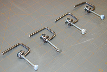 A set of four board edge clamps.