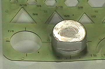 A drafting template used to draw circles used to measure the diameter of the gasket cut-out