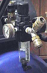 A water trap and pressure regulator must be used with an air compressor.