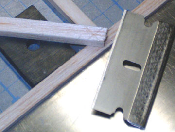 Mark the cut lines with a single-edge razor blade.  Take care aligning the blade such that it is parallel to the sides of the corner.