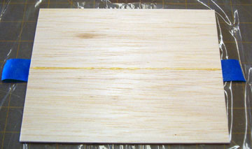 Press the sheet down flat on the building board.