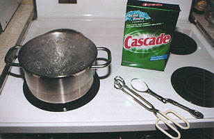 A pot of boiling water and automatic dishwashing detergent are used to clean the engine