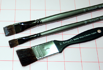 Flat, natural hair paint brushes.